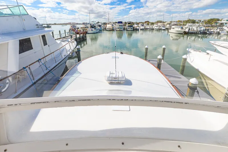 Slide: The Image of 1999 Viking 55 Convertible yacht docked in a marina, surrounded by other boats. - 20