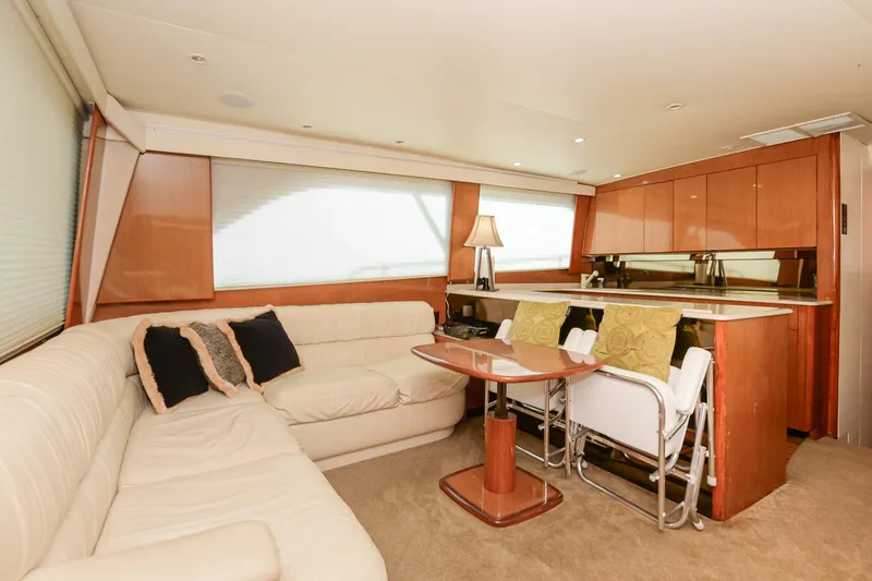 Slide: The Image of Interior of 1999 Viking 55 Convertible yacht with plush seating and elegant wood finishes. - 33