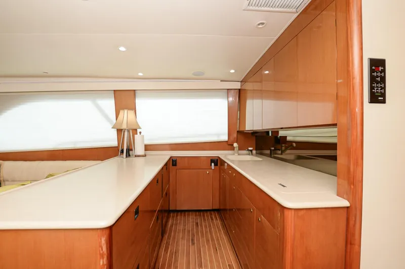 Slide: The Image of Interior of 1999 Viking 55 Convertible yacht with wooden cabinetry and modern lighting. - 41