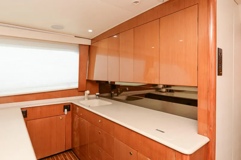 Slide: The Image of 1999 Viking 55 Convertible yacht interior with sleek wooden cabinetry and modern countertops. - 42