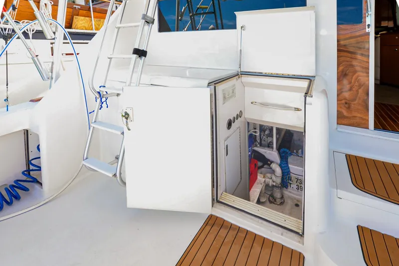 Slide: The Image of 1999 Viking 55 Convertible yacht interior with open storage compartment and ladder. - 6