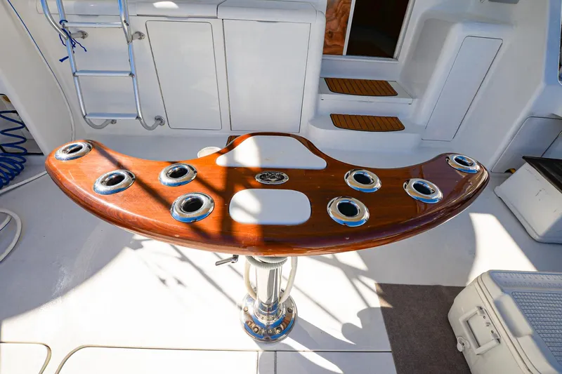 Slide: The Image of 1999 Viking 55 Convertible yacht cockpit with wooden fighting chair and rod holders. - 7