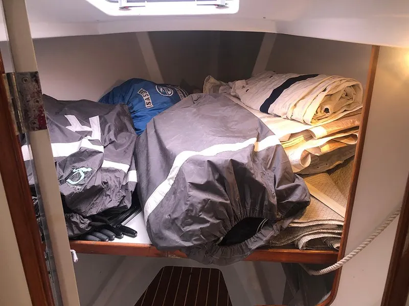 Slide: The Image of Storage area in a 1991 Concordia Taylor 42 sailboat with folded sails and gear. - 10
