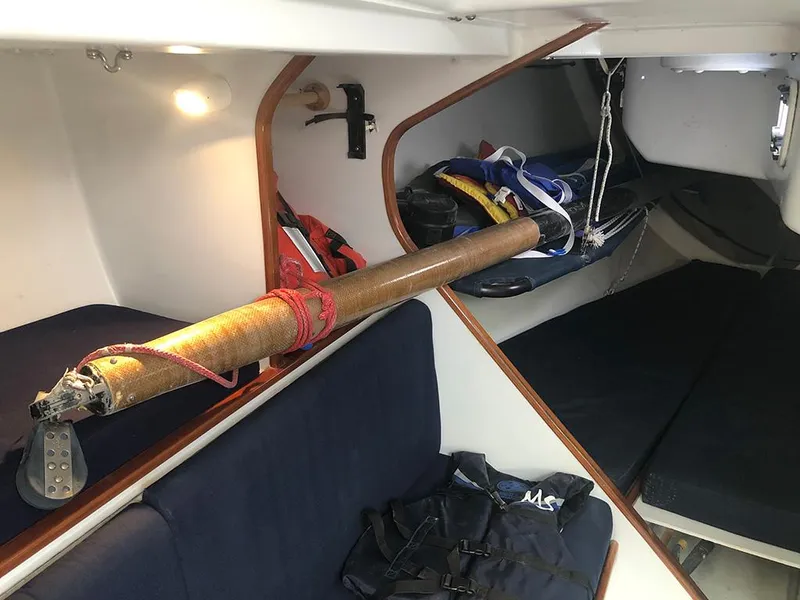 Slide: The Image of Interior of 1991 Concordia Taylor 42 sailboat with blue seating and stored equipment. - 15