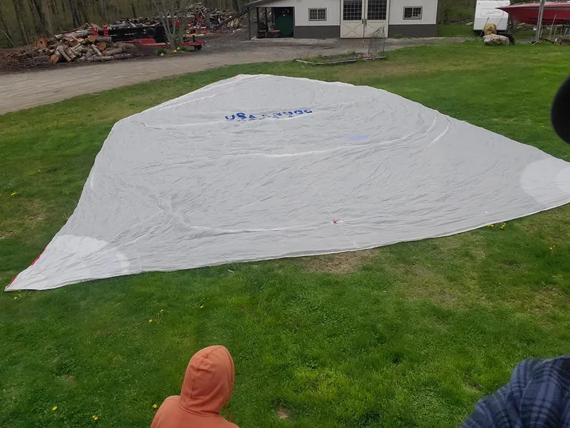 Slide: The Image of Large sail spread on grass near a building, Concordia Taylor 42, 1991 model. - 26