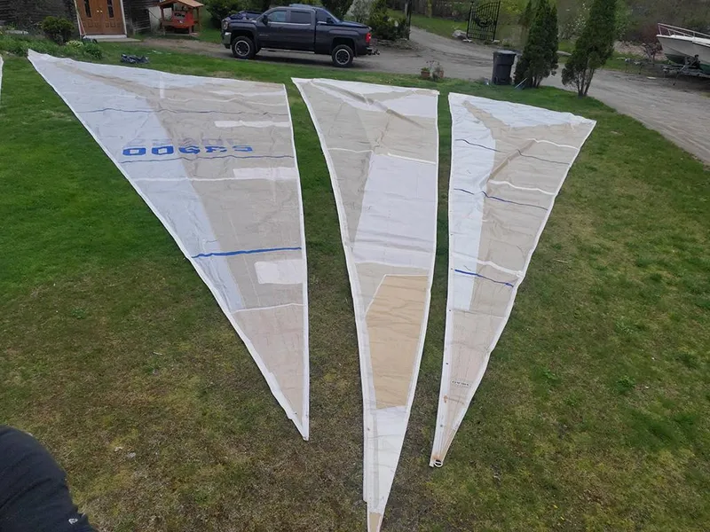 Slide: The Image of Three large sails from a 1991 Concordia Taylor 42 yacht displayed on grass. - 28