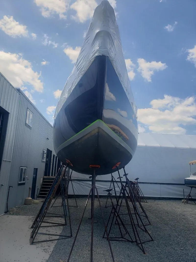 Slide: The Image of Concordia Taylor 42 sailboat from 1991 on stands, under a clear blue sky. - 31