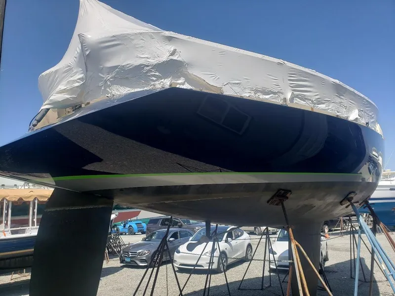Slide: The Image of Concordia Taylor 42 sailboat from 1991, covered and elevated, in a boatyard setting. - 34