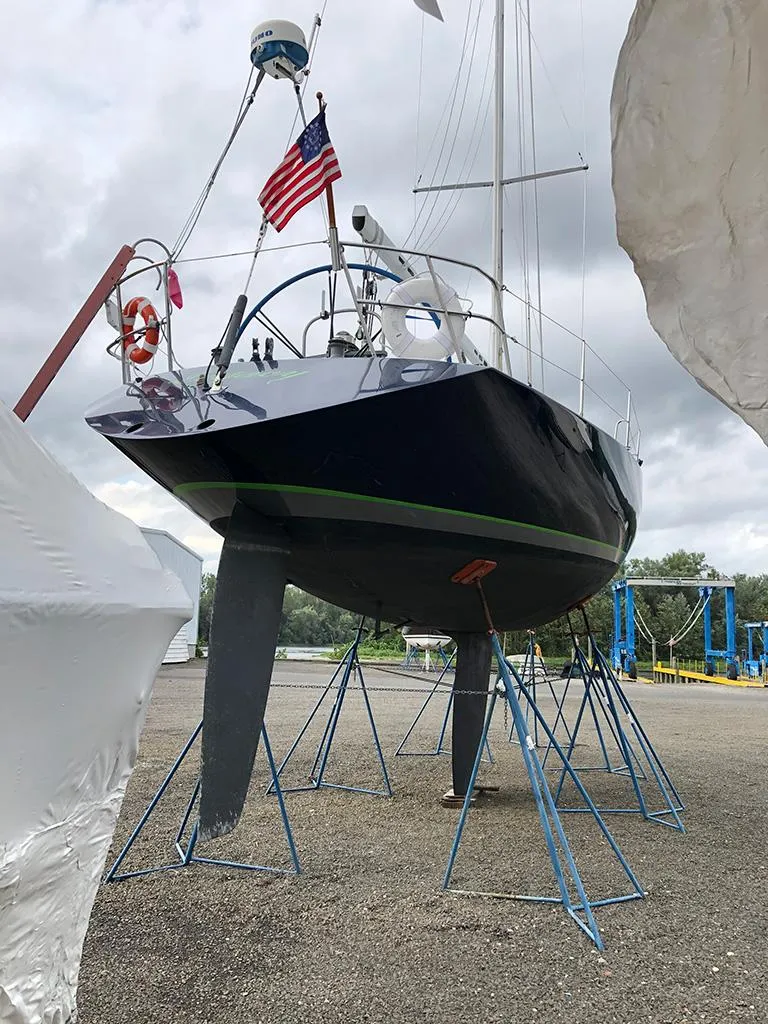 Slide: The Image of Sailboat Concordia Taylor 42 (1991) on stands, with American flag, overcast sky. - 6