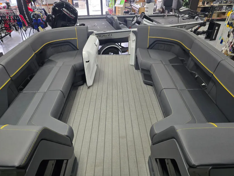 Slide: The Image of 2025 Manitou Explore Navigator boat interior with sleek gray seating and modern design. - 3