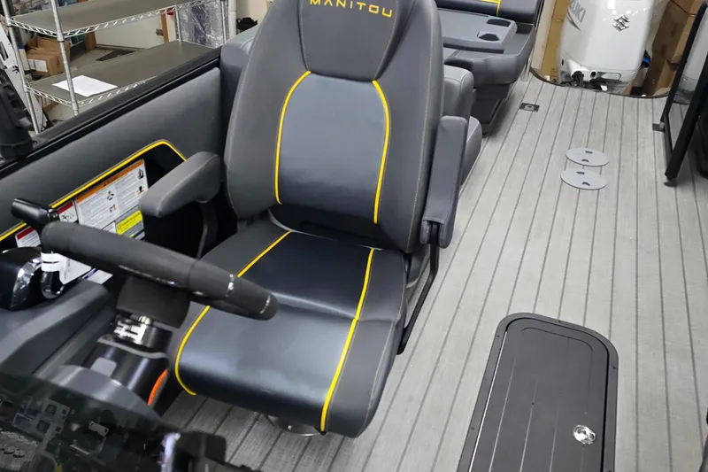 Slide: The Image of 2025 Manitou Explore Navigator boat interior with sleek seating and modern design. - 5