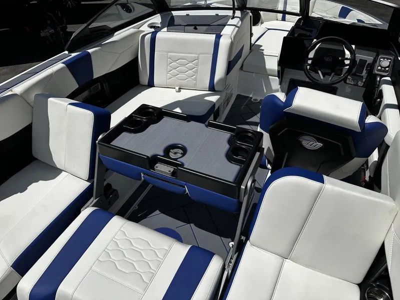 Slide: The Image of Interior of 2025 Malibu Wakesetter 23LSV boat with white and blue seating. - 11