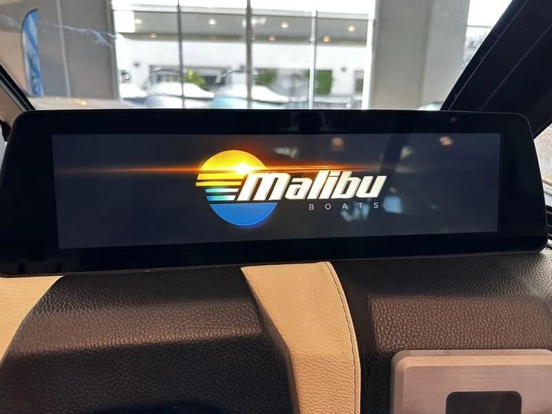 Slide: The Image of 2025 Malibu Wakesetter 23LSV dashboard display with logo in showroom. - 12