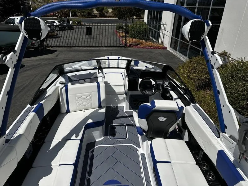 Slide: The Image of 2025 Malibu Wakesetter 23LSV boat interior with blue and white seating. - 3