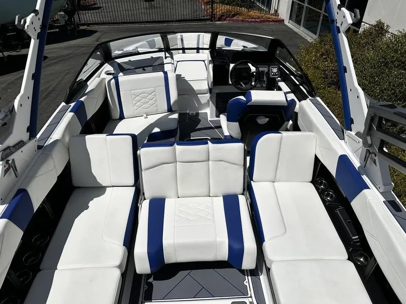 Slide: The Image of 2025 Malibu Wakesetter 23LSV boat interior with white and blue seating. - 4