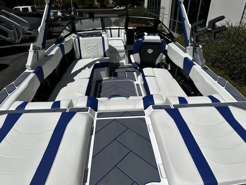 Slide: The Image of 2025 Malibu Wakesetter 23LSV interior with white and blue seating, modern design. - 5
