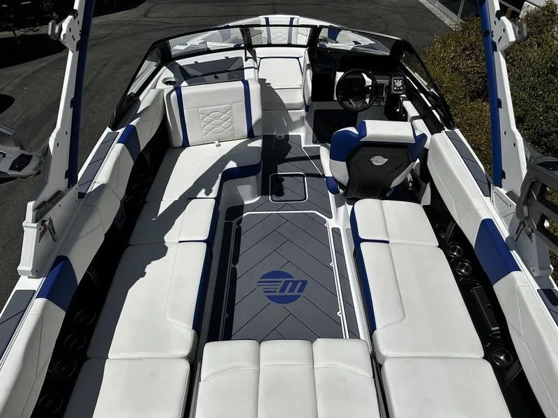Slide: The Image of 2025 Malibu Wakesetter 23LSV interior with white and blue seating, sleek design. - 6