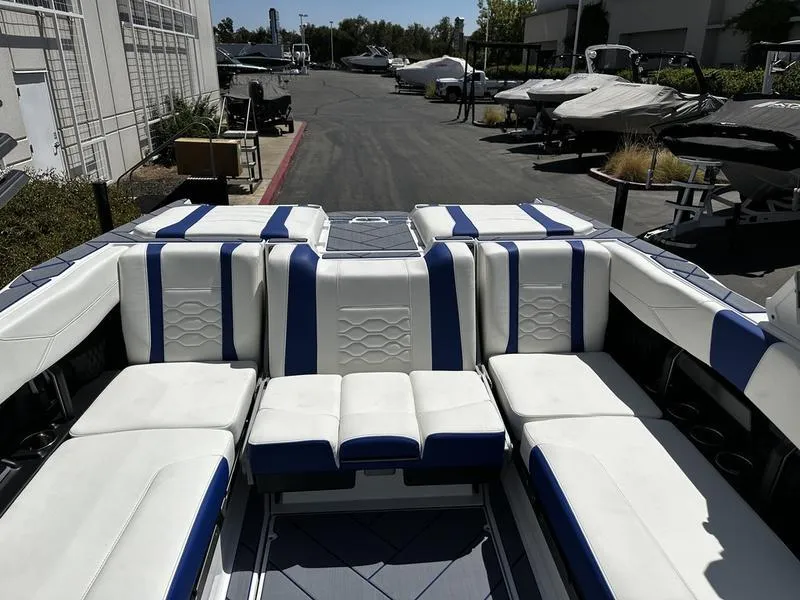 Slide: The Image of 2025 Malibu Wakesetter 23LSV boat interior with white and blue seating. - 7
