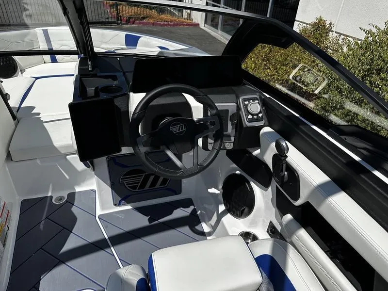 Slide: The Image of 2025 Malibu Wakesetter 23LSV boat interior with modern dashboard and steering wheel. - 9