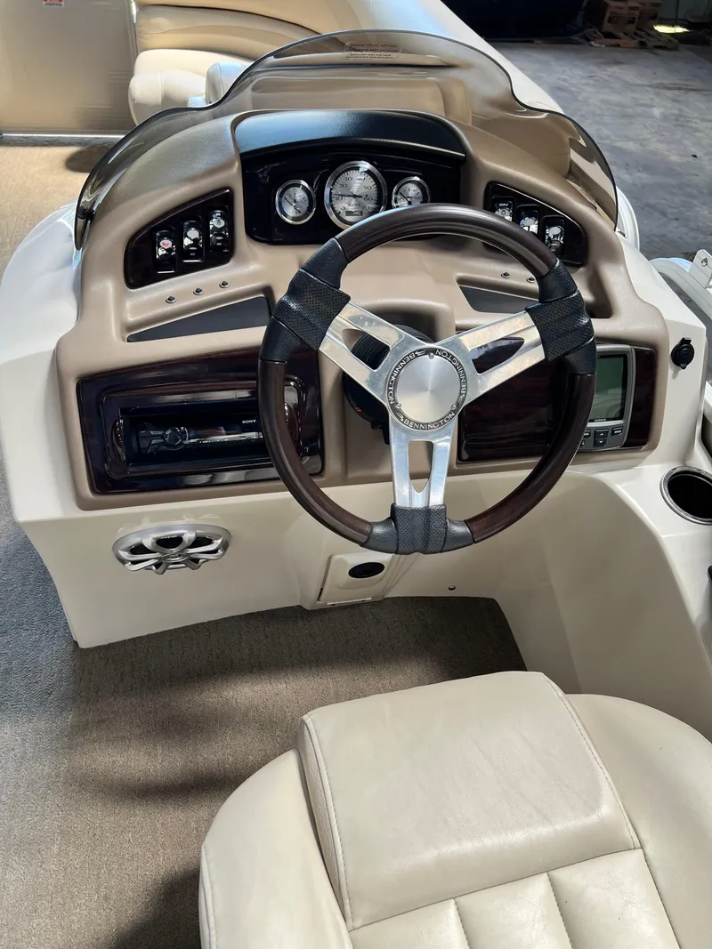 Slide: The Image of 2014 Bennington 2250 GSR boat dashboard with steering wheel and control panel. - 4