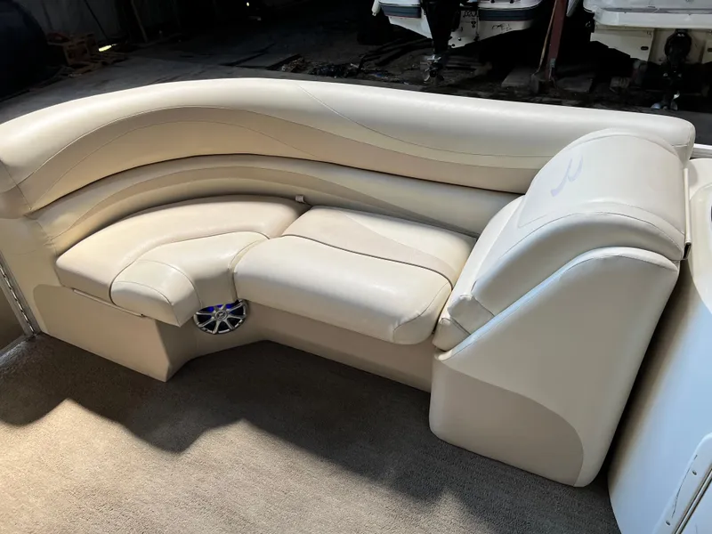 Slide: The Image of 2014 Bennington 2250 GSR boat interior with beige seating and speaker. - 6