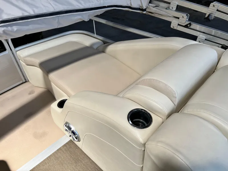 Slide: The Image of 2014 Bennington 2250 GSR boat interior with beige leather seating and cup holders. - 8