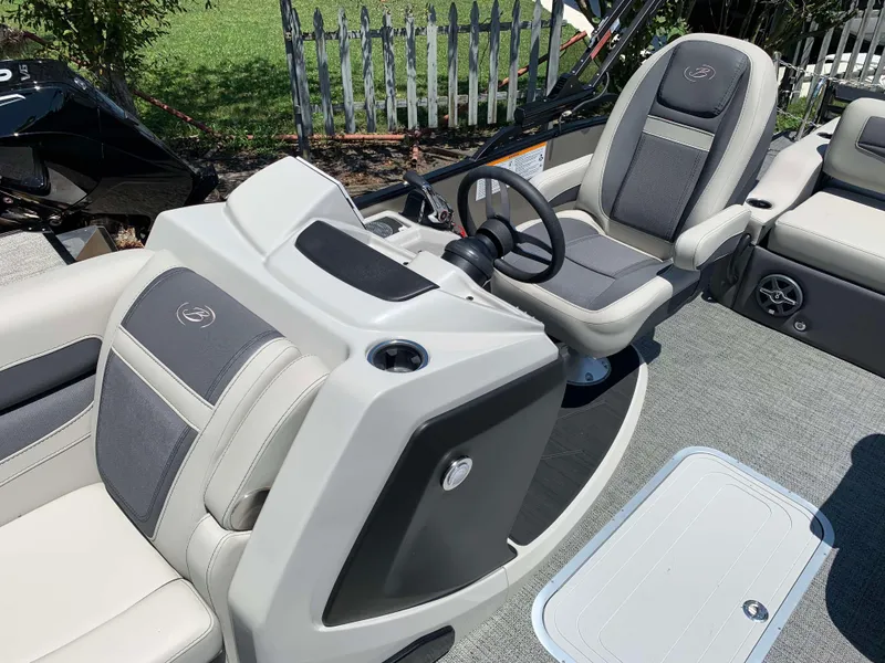 Slide: The Image of 2025 Barletta Cabrio 22UC boat interior with steering console and seating. - 14