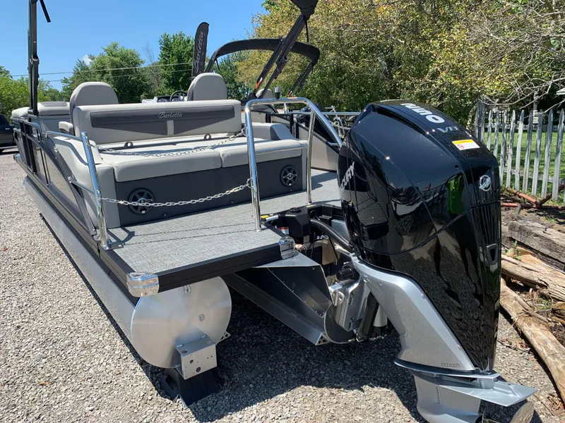 Slide: The Image of 2025 Barletta Cabrio 22UC pontoon boat with powerful outboard motor, parked outdoors. - 2