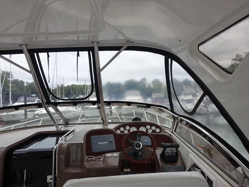 Slide: The Image of Interior view of 2006 Regal 3560 Commodore yacht cockpit with steering wheel and navigation equipment. - 10