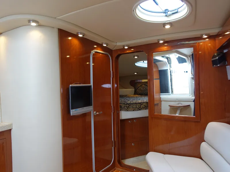 Slide: The Image of Luxurious interior of 2006 Regal 3560 Commodore yacht with wood finish and modern amenities. - 13