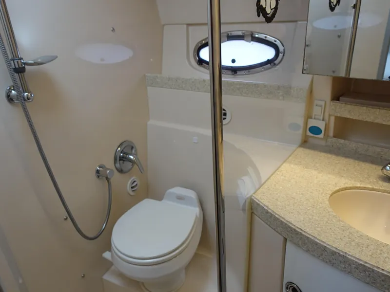 Slide: The Image of 2006 Regal 3560 Commodore yacht bathroom with shower, toilet, and sink. - 17