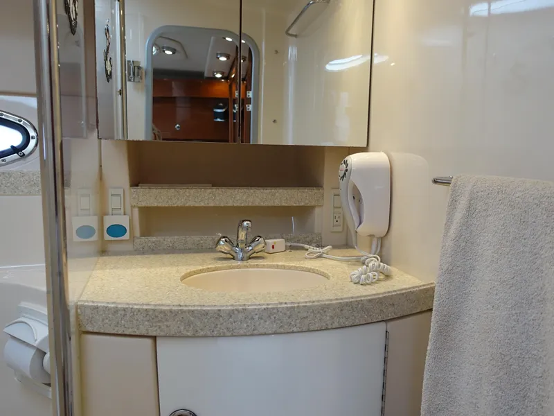 Slide: The Image of 2006 Regal 3560 Commodore yacht bathroom with sink, mirror, and towel. - 18