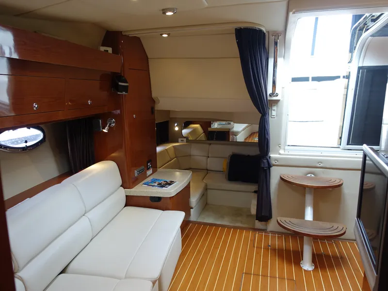 Slide: The Image of Luxurious interior of 2006 Regal 3560 Commodore yacht with elegant seating and wood flooring. - 19