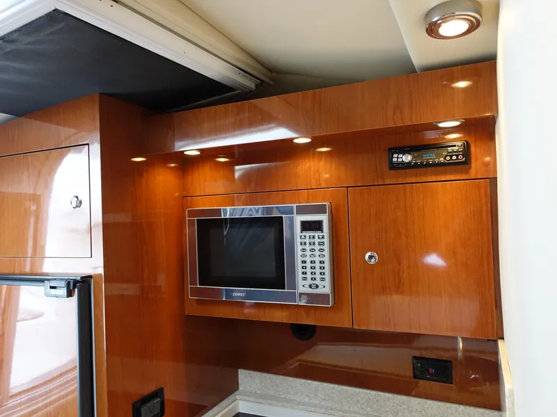 Slide: The Image of 2006 Regal 3560 Commodore yacht kitchen with microwave and wood cabinetry. - 20