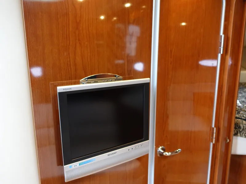 Slide: The Image of Flat-screen TV on 2006 Regal 3560 Commodore yacht's wooden interior wall. - 24