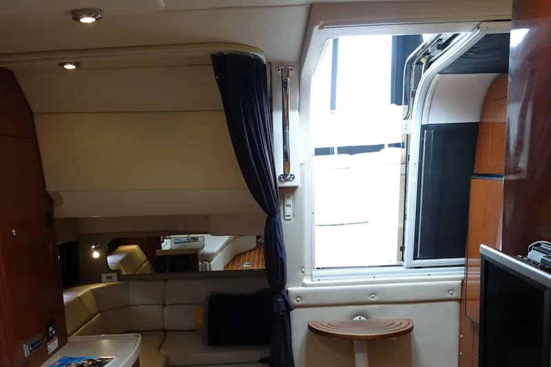 Slide: The Image of Interior of 2006 Regal 3560 Commodore yacht with seating and open hatch. - 25