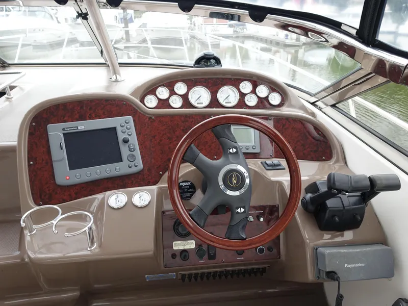 Slide: The Image of 2006 Regal 3560 Commodore boat dashboard with steering wheel and navigation controls. - 3