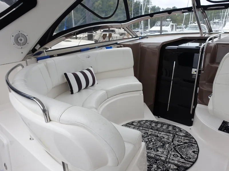 Slide: The Image of Luxurious 2006 Regal 3560 Commodore yacht interior with white seating and decorative rug. - 7