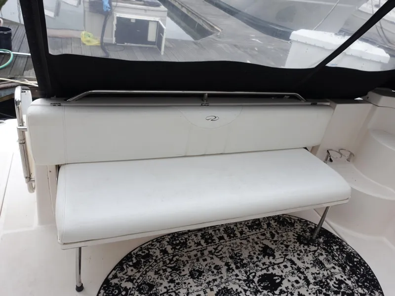 Slide: The Image of White bench seat on 2006 Regal 3560 Commodore boat, with black and white rug. - 8
