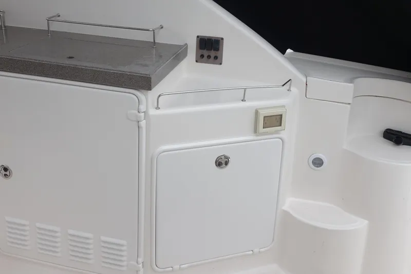 Slide: The Image of 2006 Regal 3560 Commodore boat interior with storage compartments and control panel. - 9