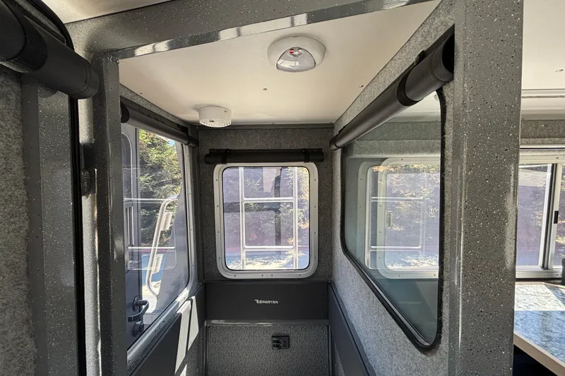 Slide: The Image of Interior of 2025 Spartan 2600 Olympia boat with windows and textured walls. - 22