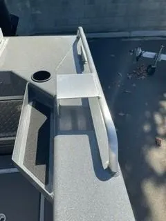Slide: The Image of 2025 Spartan 2600 Olympia boat deck with railing and storage compartment. - 13