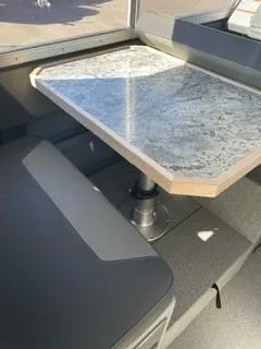 Slide: The Image of 2025 Spartan 2600 Olympia interior with a sleek, modern table and seating area. - 15