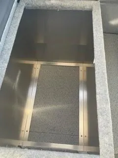 Slide: The Image of 2025 Spartan 2600 Olympia storage compartment with carpeted interior and metal frame. - 17