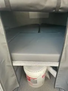 Slide: The Image of Interior of 2025 Spartan 2600 Olympia boat with storage area and cushions. - 18