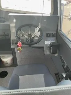 Slide: The Image of Interior of 2025 Spartan 2600 Olympia vehicle, featuring steering wheel and control panel. - 20