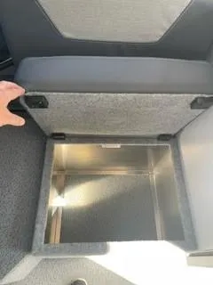 Slide: The Image of 2025 Spartan 2600 Olympia interior storage compartment with open lid. - 23