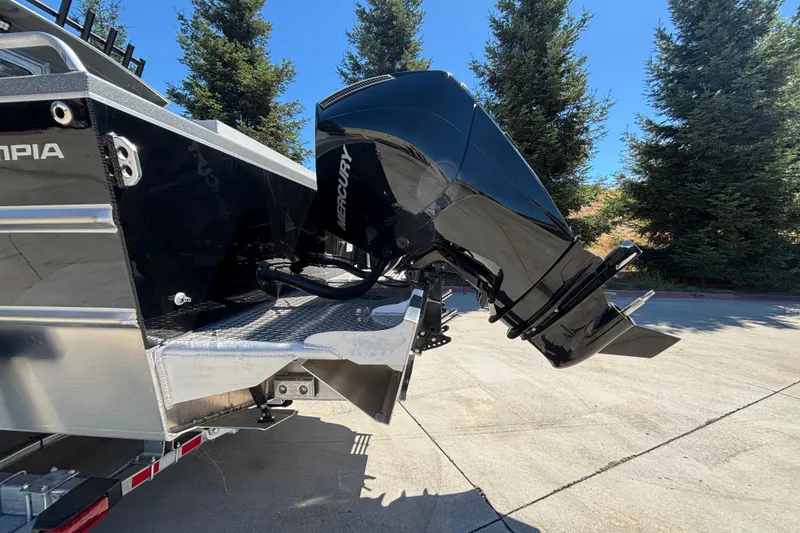 Slide: The Image of 2025 Spartan 2600 Olympia boat with Mercury outboard motor, parked outdoors. - 5