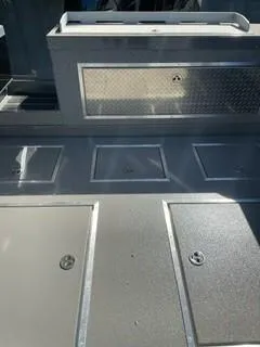 Slide: The Image of 2025 Spartan 2600 Olympia boat deck with storage compartments and metallic finish. - 30