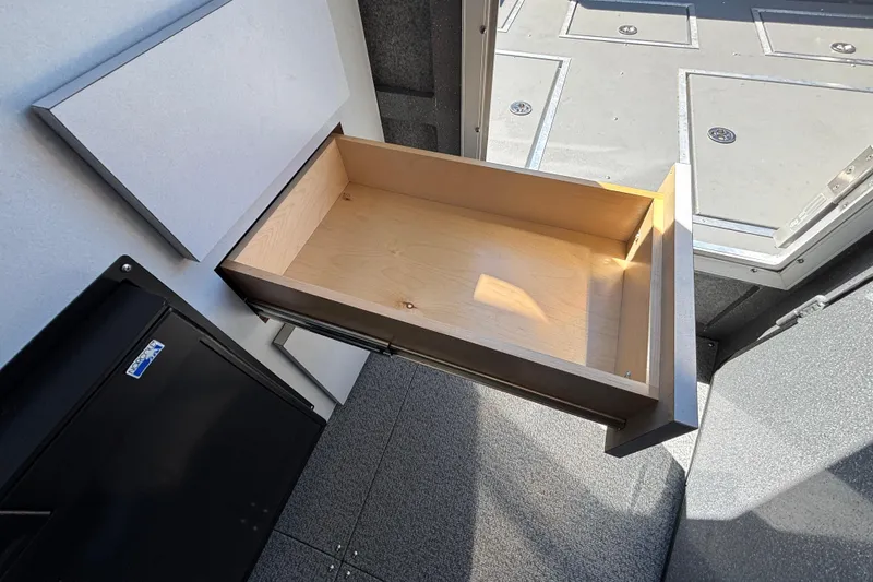 Slide: The Image of Open wooden drawer inside 2025 Spartan 2600 Olympia vehicle, showcasing interior storage space. - 55